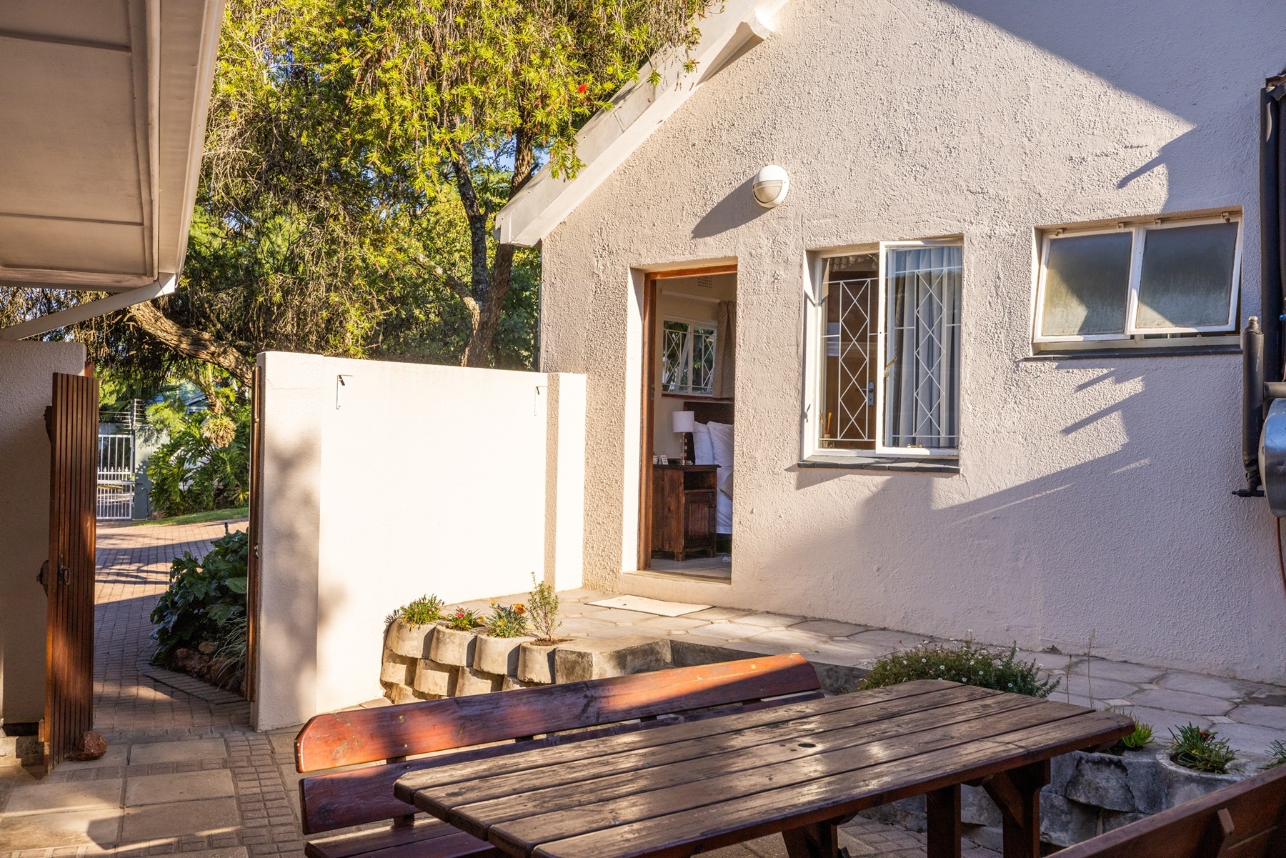 12.single_unit_entrance_and_outside_table.jpg Single unit entrance and outside table